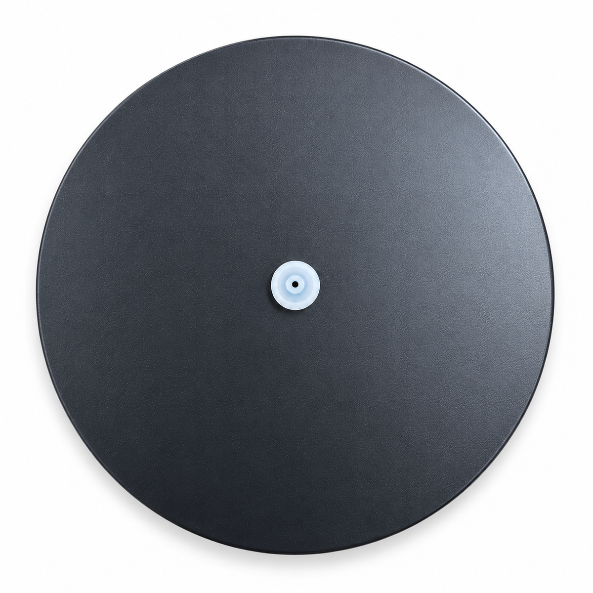 Top view of black circular wipe dispenser lid with white central dispensing nozzle